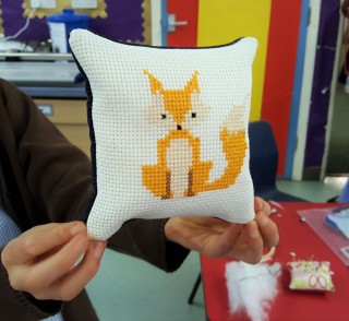 Fox cross-stitch pillow made by a Stitch Club student